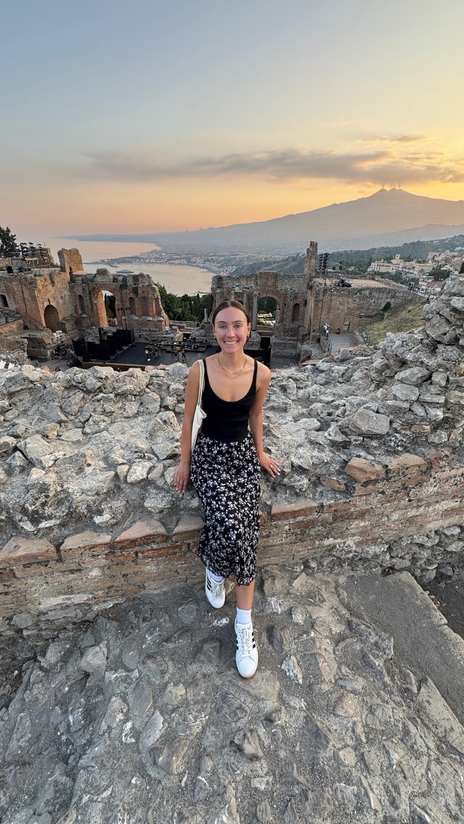Nicole at the ancient theatre of Taormina at sunset, with Mount Etna behind