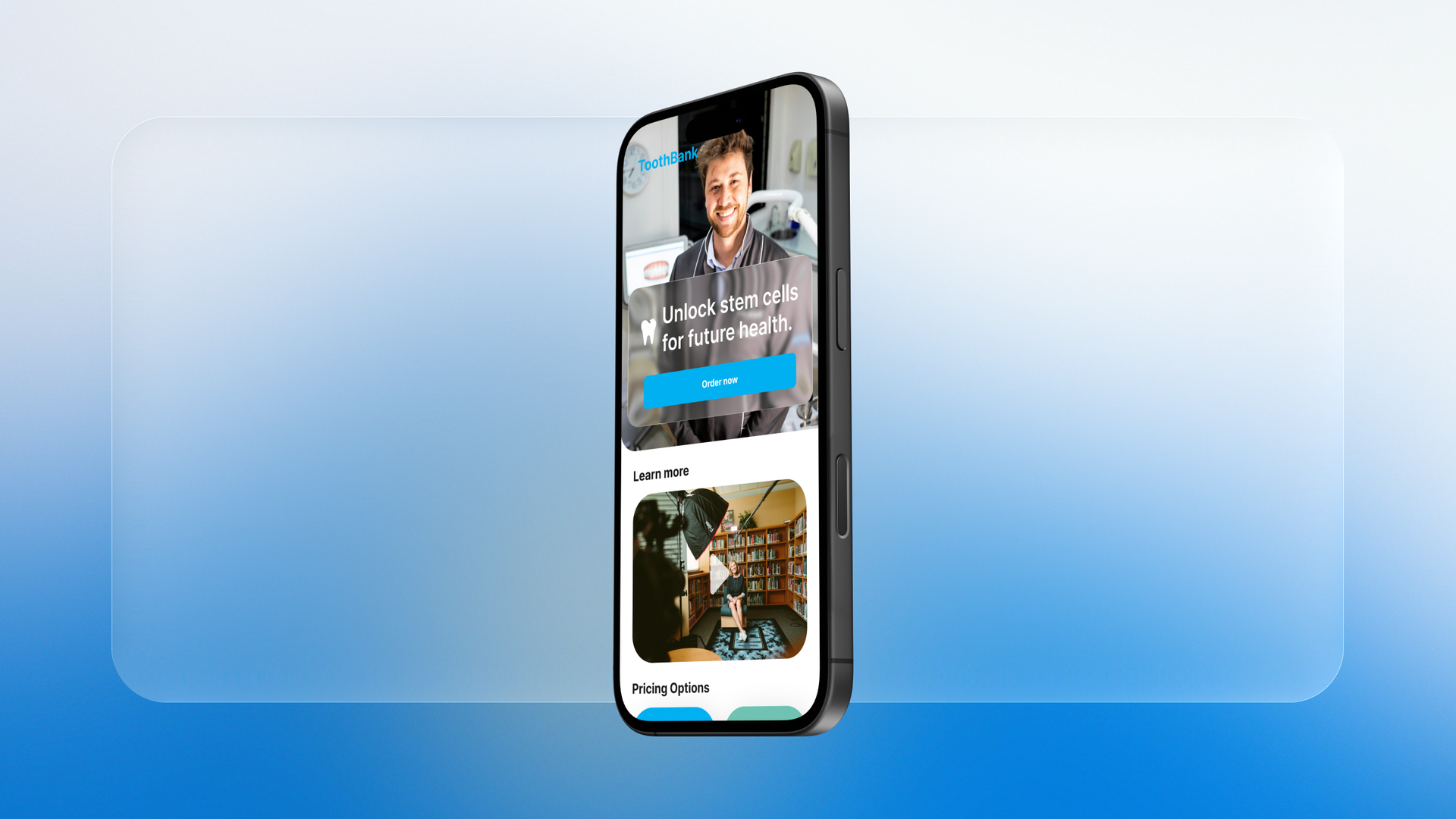 The redesigned ToothBank site on a phone, held in a hand